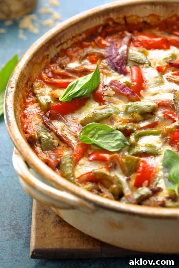 A close-up photo of the Italian Sausage and Bell Pepper Polenta Bake, freshly baked and bubbling with melted cheese, ready to be served.