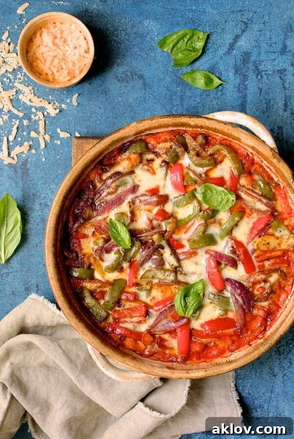 Italian Sausage and Bell Pepper Polenta Bake fresh out of the oven on wooden trivet.