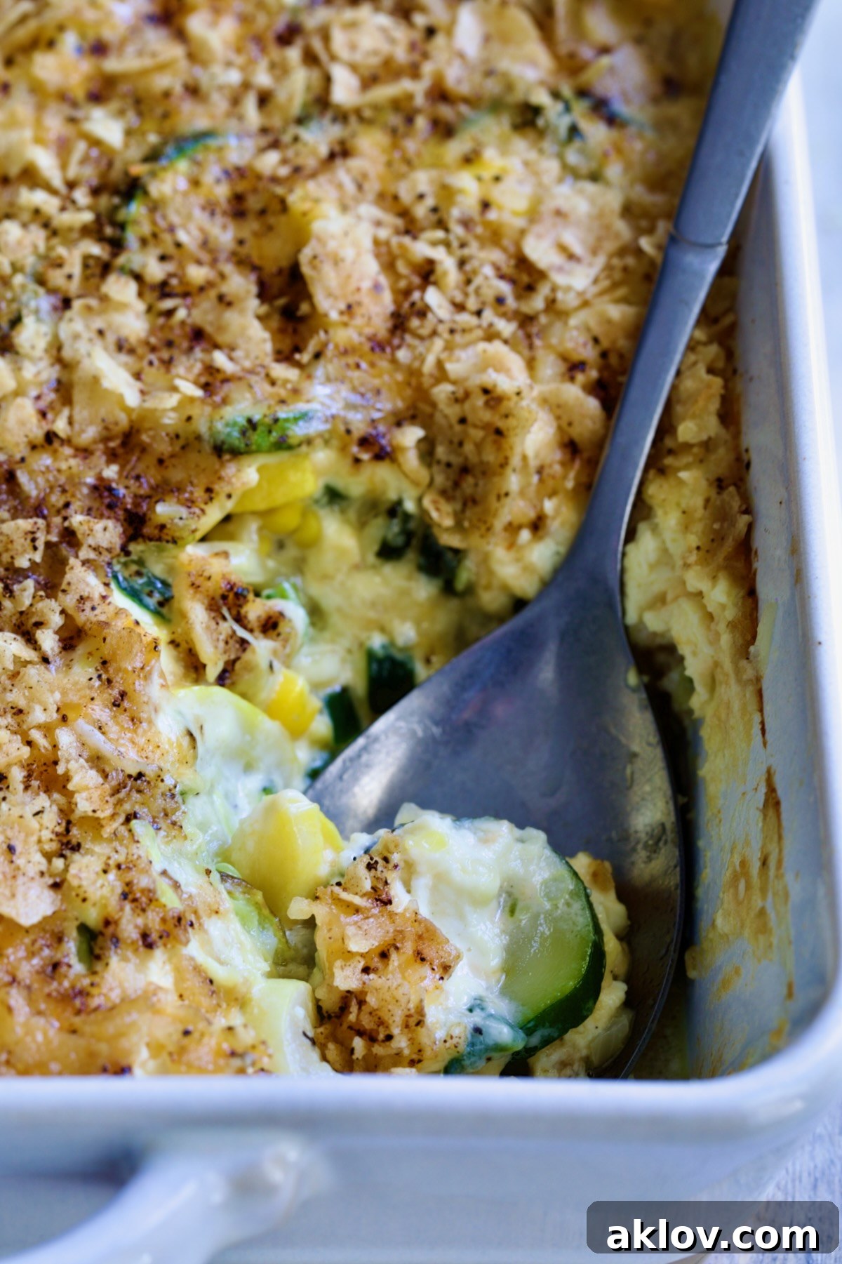 The full Summer Squash Corn Poblano Casserole dish on a table, ready for serving.