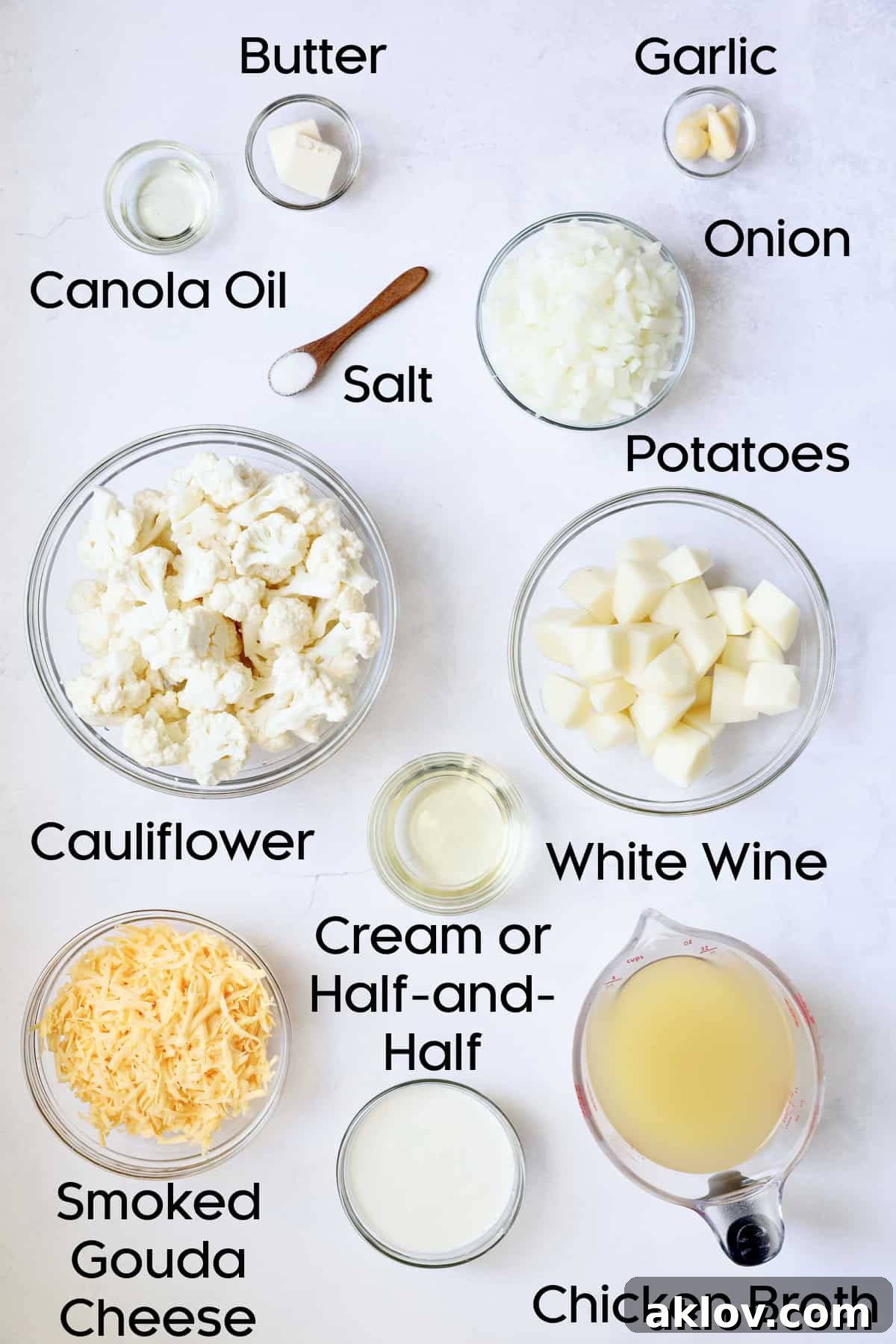 Assorted fresh ingredients for Cauliflower Potato Soup with Smoked Gouda, neatly arranged in glass bowls and ready for preparation.