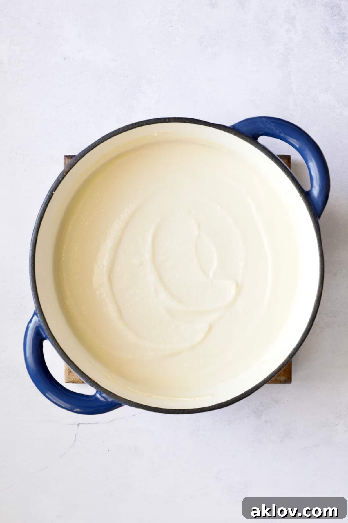 The Cauliflower Potato Soup with Smoked Gouda in a Dutch oven, now perfectly pureed to a smooth, creamy consistency, ready for serving.
