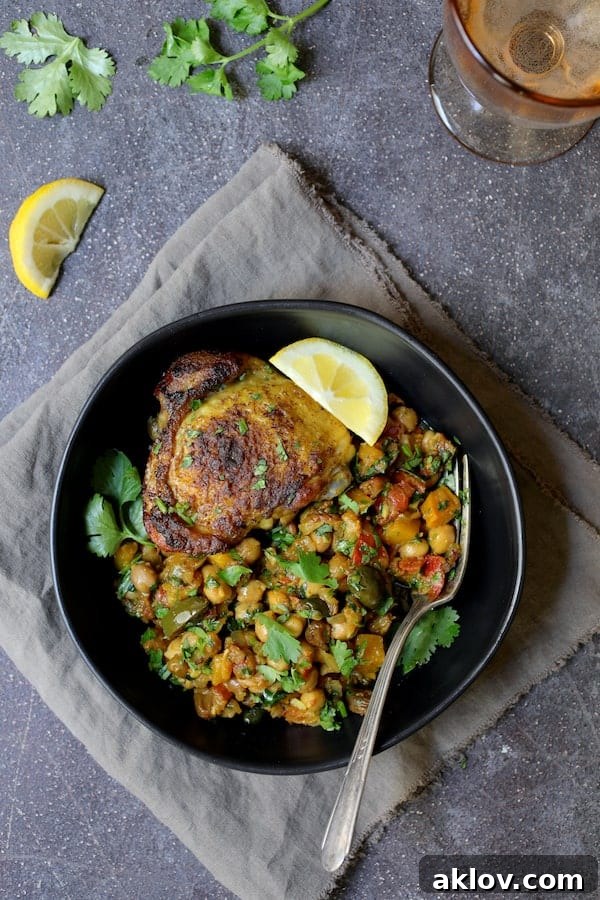 Authentic Moroccan Chicken Tagine 7 Another perspective of a single serving of Moroccan Chicken Tagine in a black bowl, highlighting the colorful ingredients.