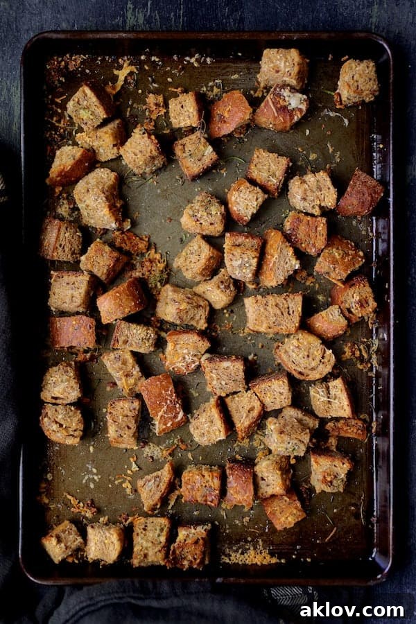 Close-up view of freshly baked Whole-Grain Thyme, Rosemary, and Parmesan Croutons.