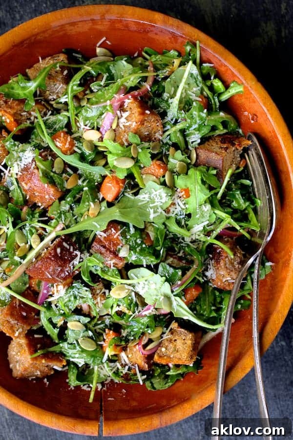 Close-up view of the Autumn Panzanella, highlighting the roasted vegetables and crunchy croutons.