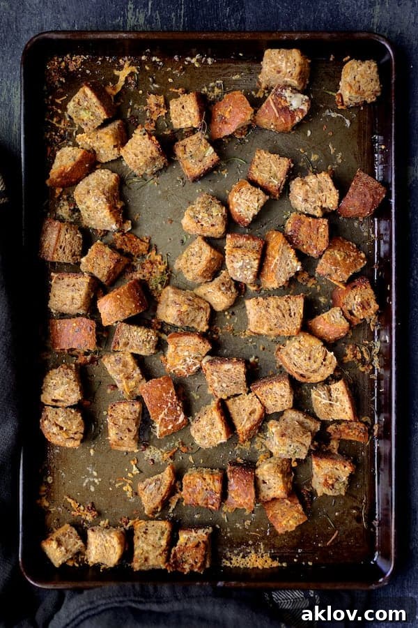 Golden brown whole-grain croutons evenly spread on a baking sheet, ready for the salad.