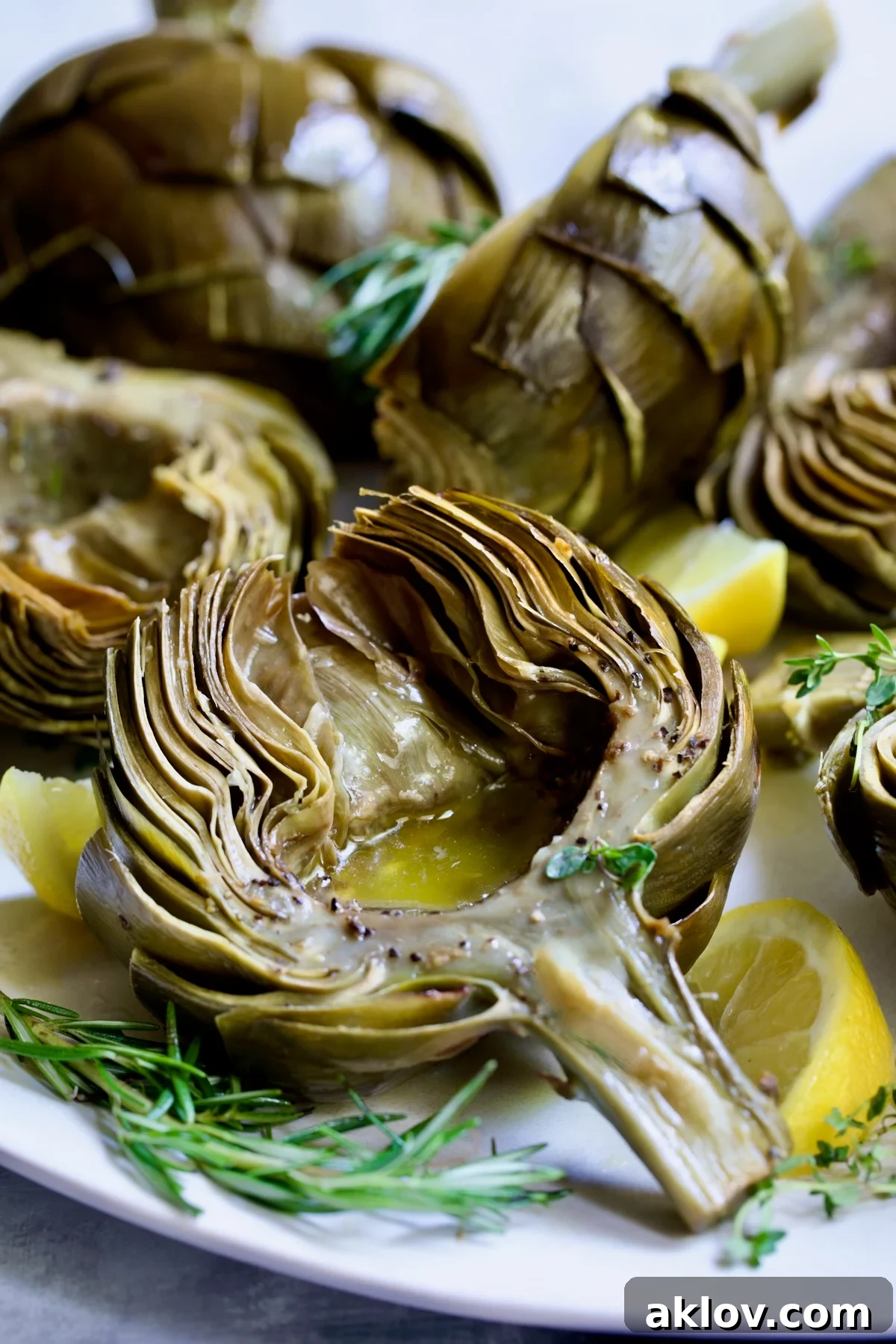Buttery Garlic Roasted Artichokes 20 Roasted Artichoke with Garlic Butter in the well of the artichoke.