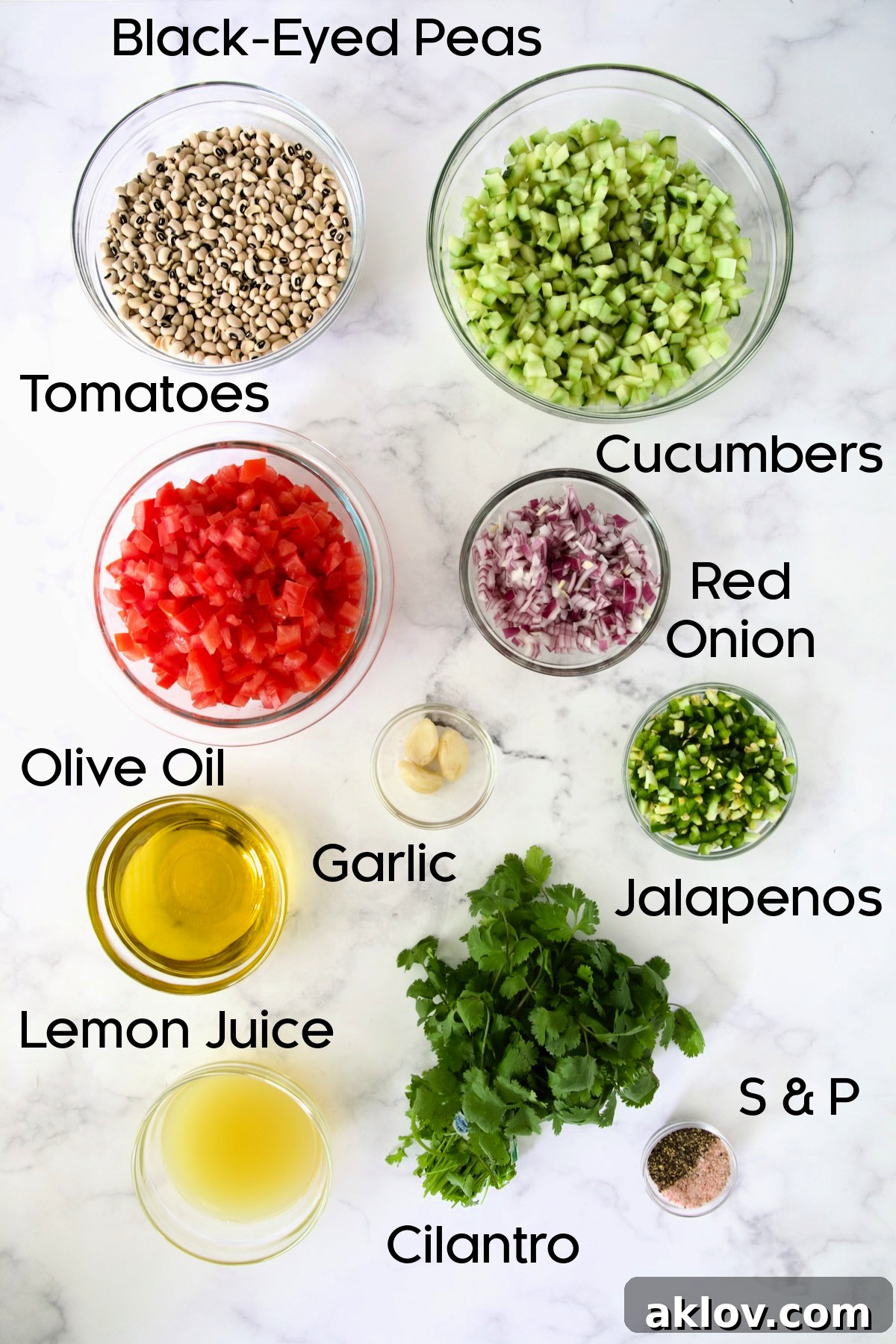A vibrant display of fresh ingredients for Black-Eyed Pea Salad, meticulously arranged in clear glass bowls, ready for preparation.