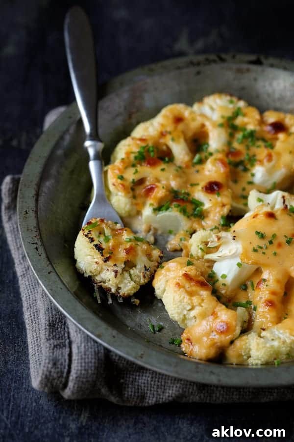An inviting close-up of Cauliflower Welsh Rarebit, with a fork lifting a cheesy piece, ready to be enjoyed.