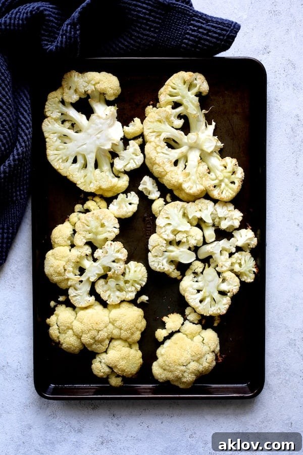 Roasted cauliflower steaks, golden-brown and tender, fresh out of the oven.