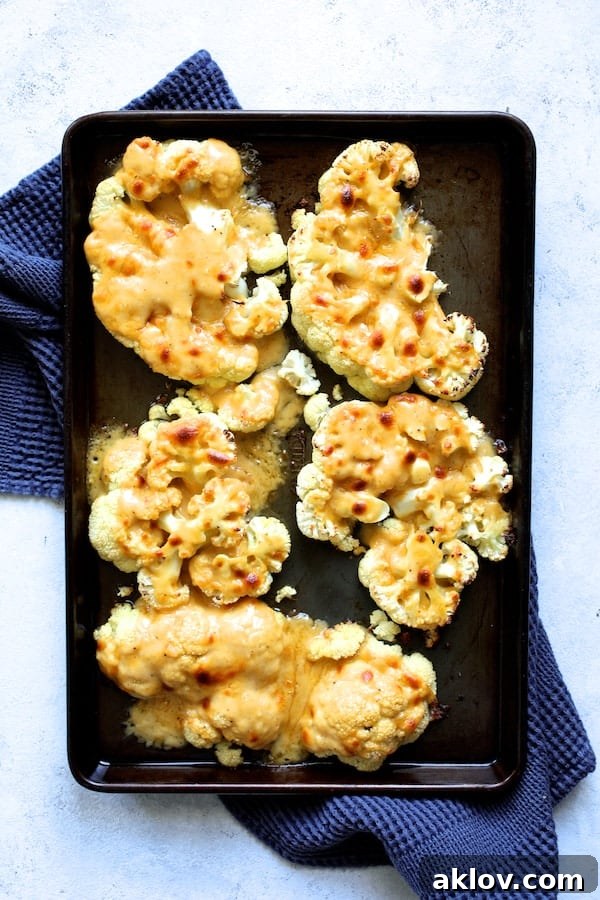 Broiled cauliflower steaks with a perfectly golden and bubbling cheese topping.