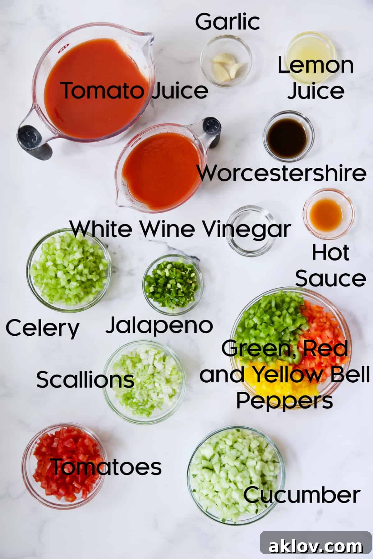 A collection of fresh ingredients for Very Veggie Gazpacho, neatly arranged in various glass bowls.