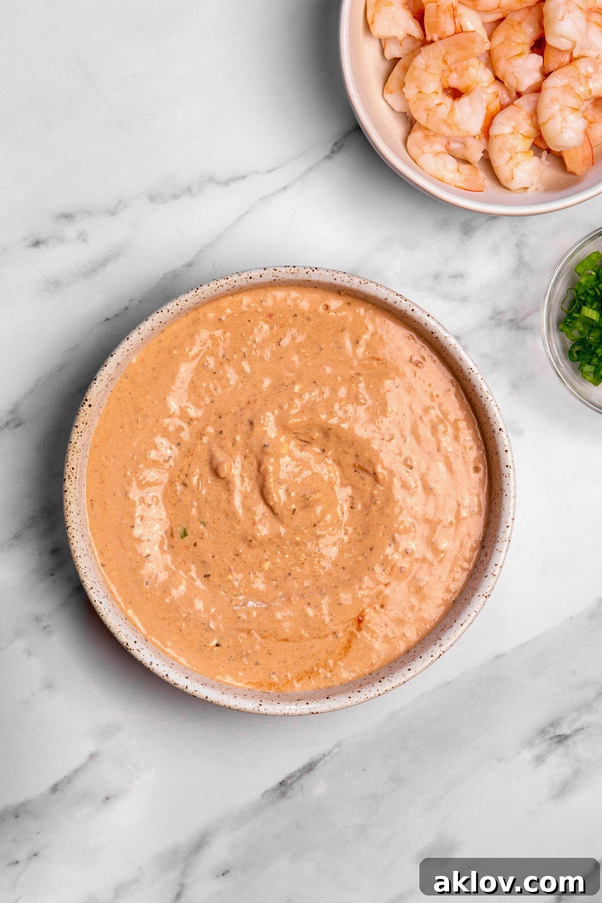 Close-up view of the creamy dip base in a mixing bowl before shrimp is added, showing its smooth texture.