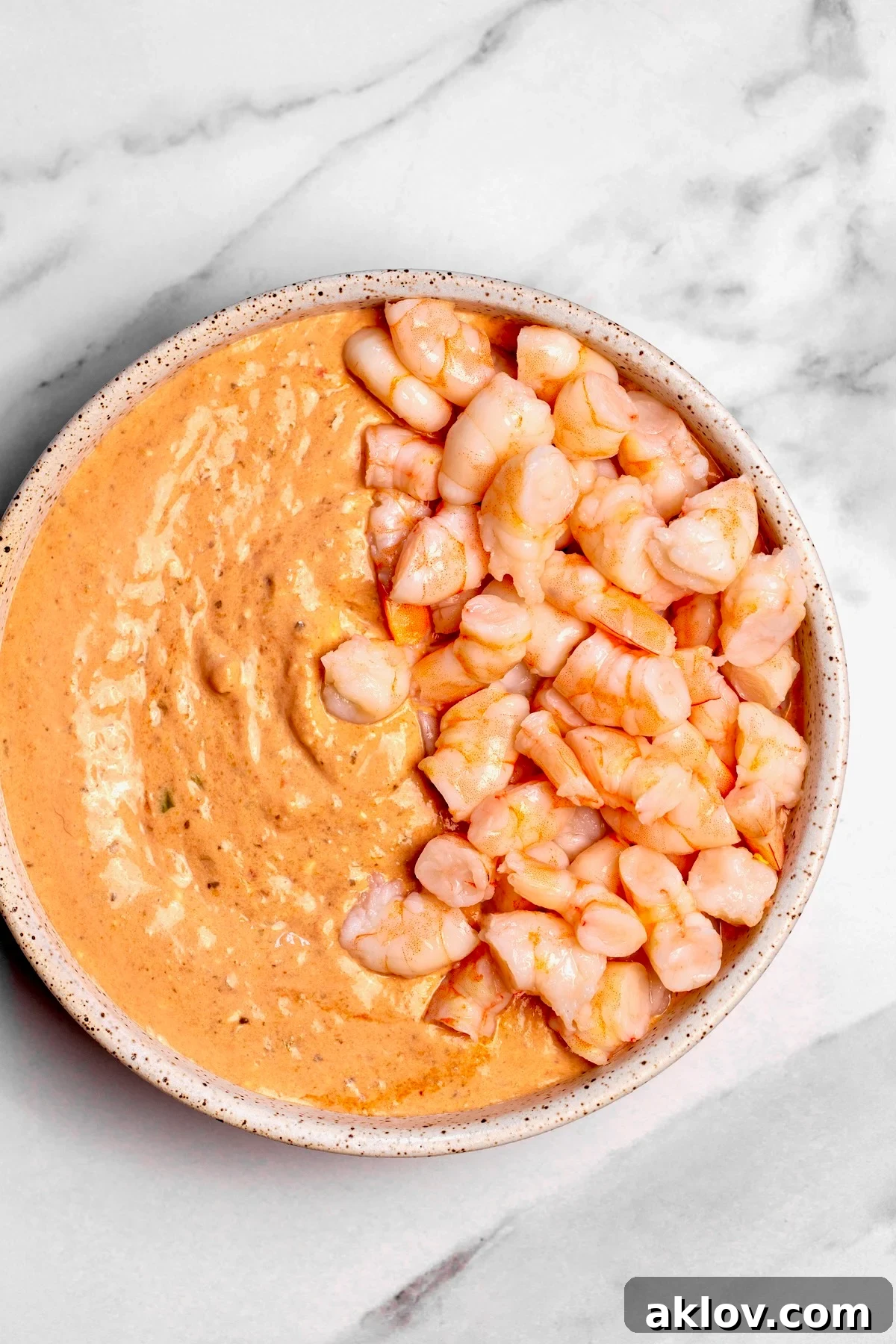 Shrimp dip with shrimp on half.