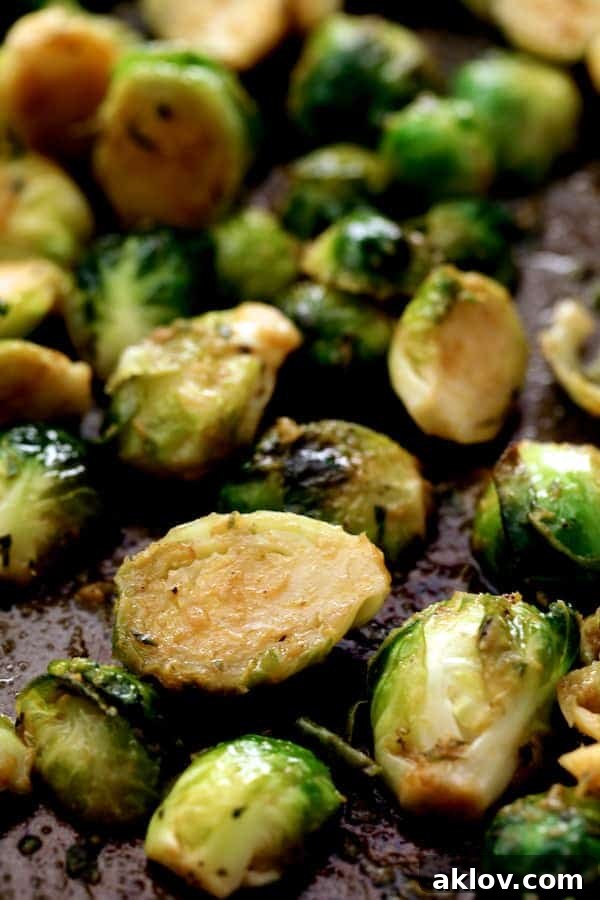 A close-up view of perfectly roasted Brussels sprouts, showcasing their crispy edges and vibrant green color.