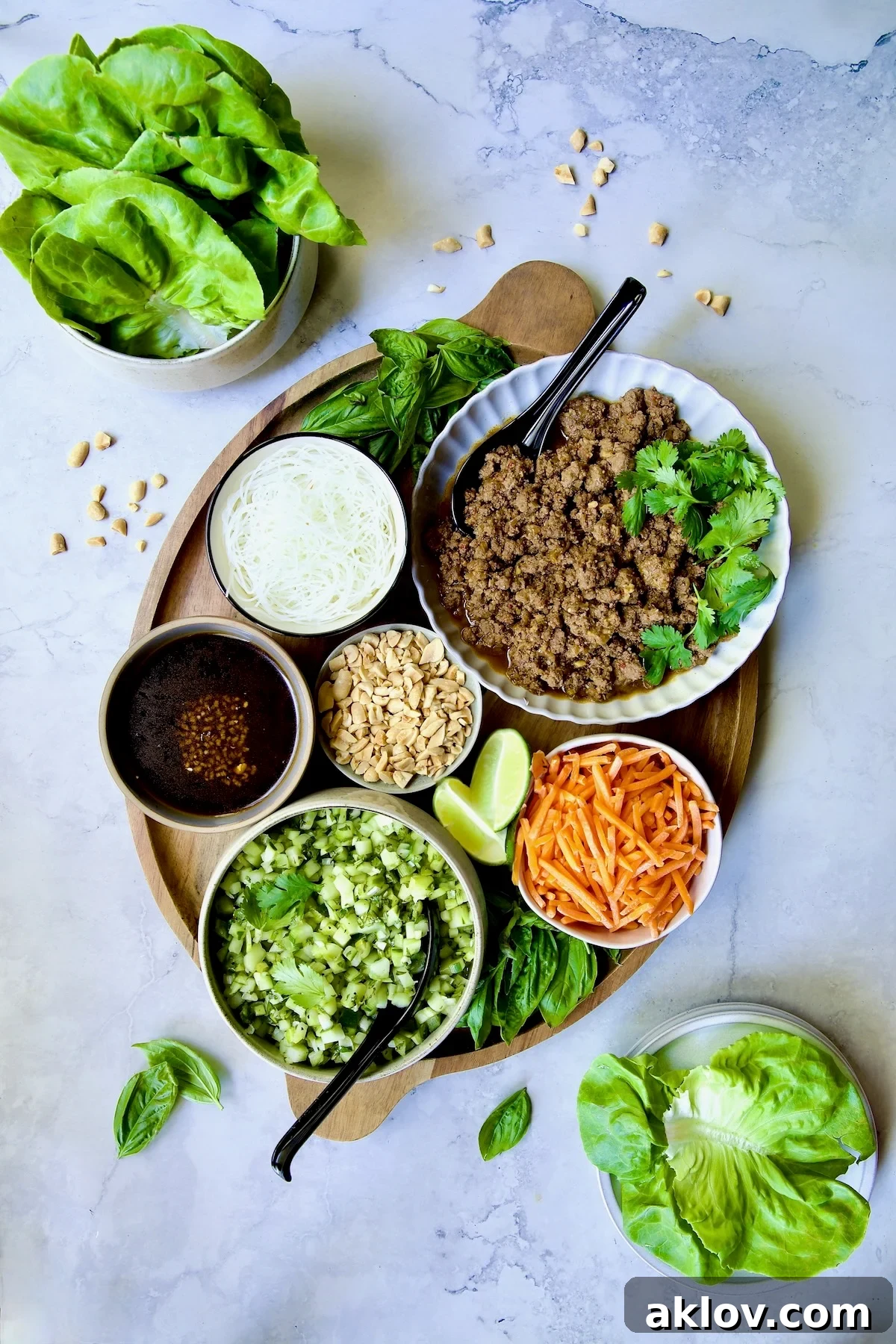 All the fixings for Vietnamese Beef Lettuce Wraps on oval wood platter.