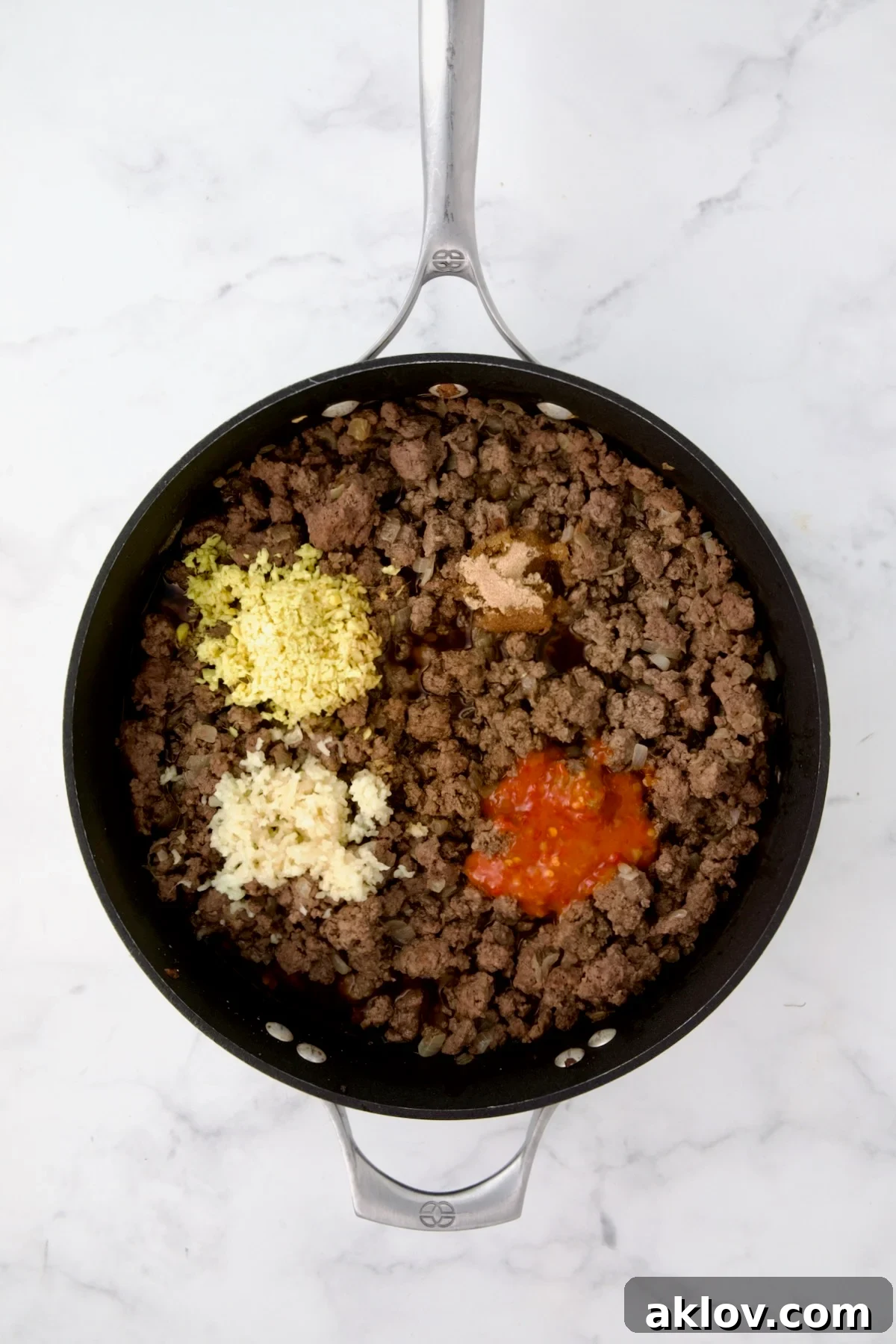 Cooked ground beef in nonstick skillet with ginger, garlic, chili sauce, soy sauce, brown sugar and chicken broth.