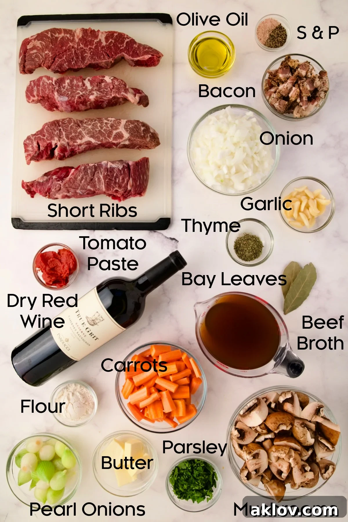 Collection of ingredients for Short Ribs Bourguignon, arranged in clear glass bowls.