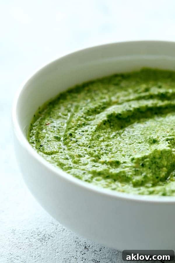 Close-up photo of the finished Creamy Cashew and Spinach Pesto Sauce in a white bowl, showcasing its smooth texture.