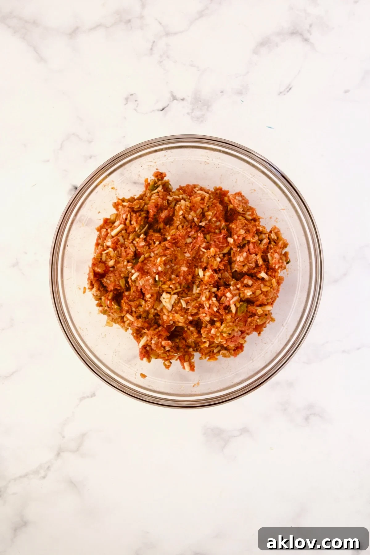 Mixed ingredients for the pepper filling in a glass bowl, ready to be stuffed.