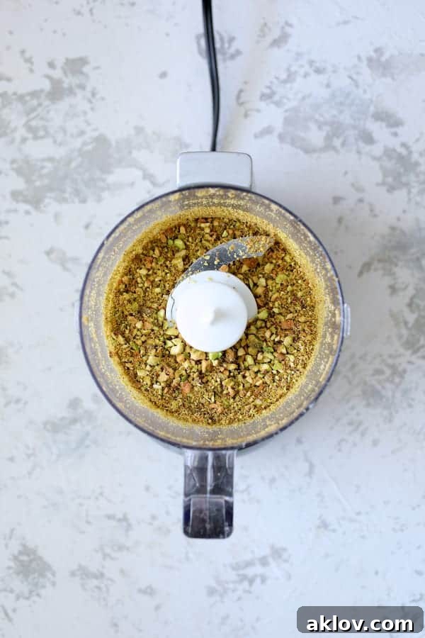 Photo of chopped pistachios in mini food processor.