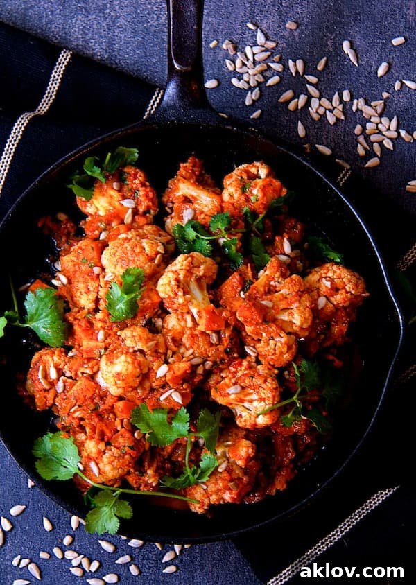 Photo of Cauliflower and Sweet Potatoes in Roasted Red Pepper Mole in cast iron skillet.