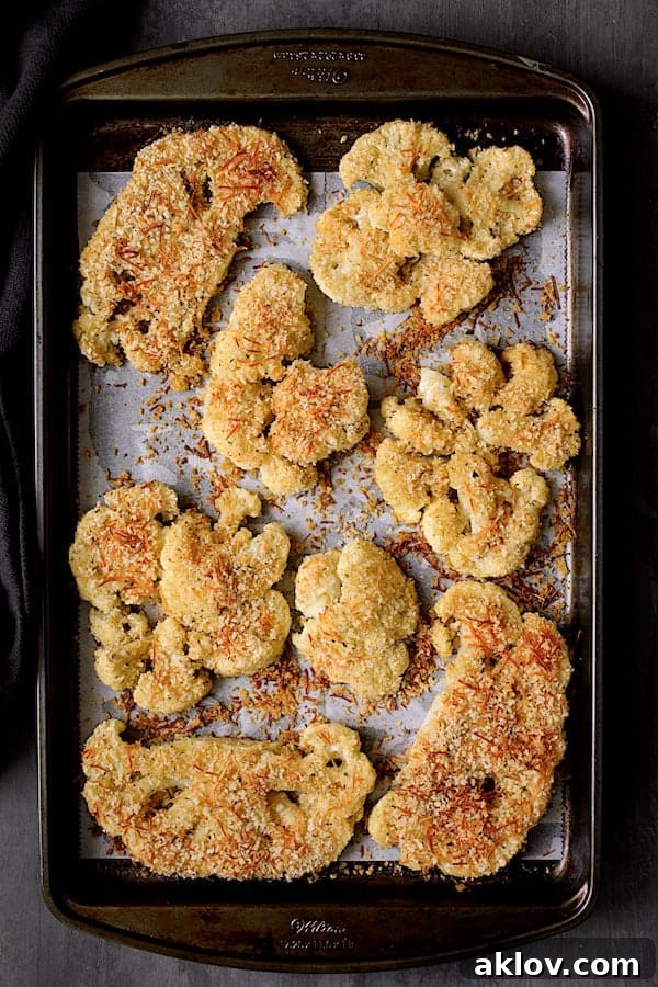 Photo of cauliflower steaks on baking sheet after being baked.