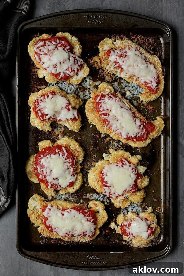 The finished Cauliflower Parmigiana, hot from the oven with its melted, bubbly cheese and rich sauce, ready for immediate serving.
