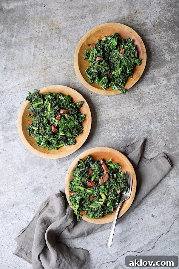 Spicy Sautéed Kale with Andouille Sausage - Overhead shot of dish on three wooden plates