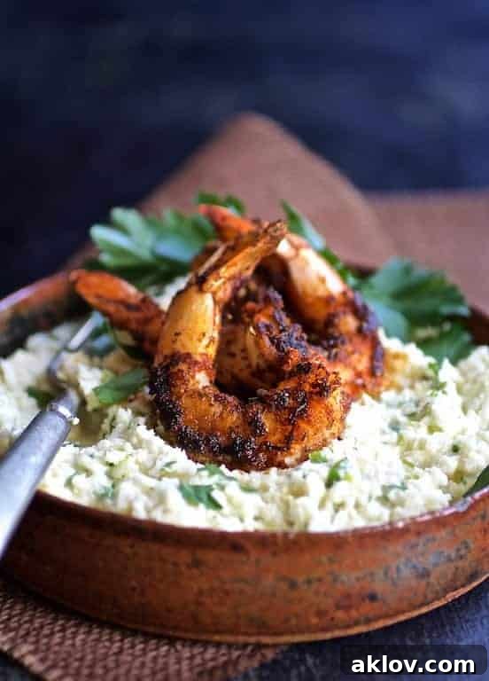 Cauliflower Gouda Grits and Blackened Shrimp in earthenware bow.