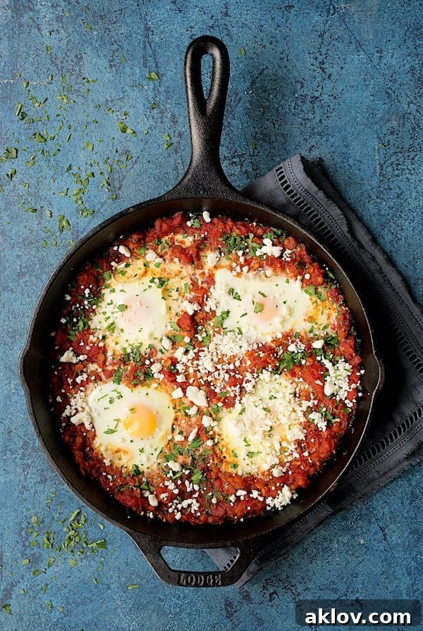 Shakshuka with Red Lentils and Feta Cheese in a cast iron skillet.