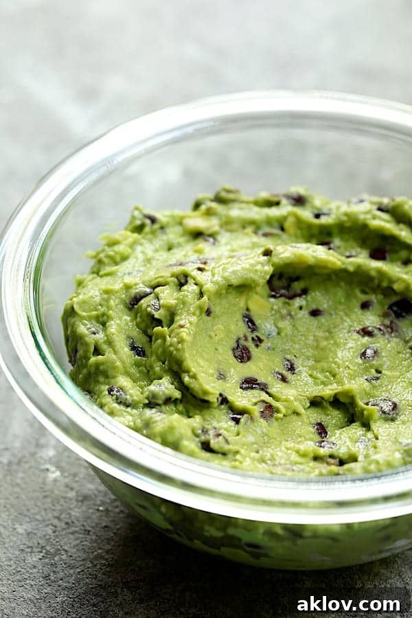 Photo of black bean guacamole in glass bowl.
