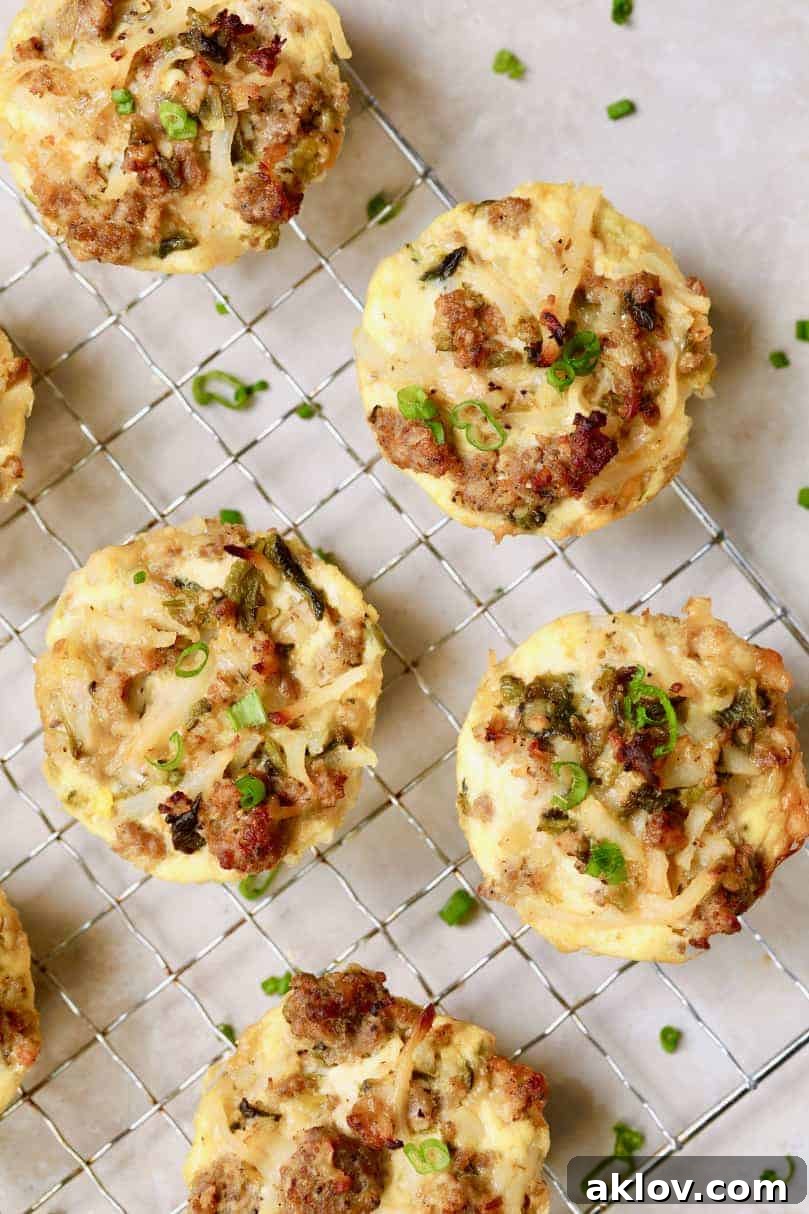 Golden brown Hash Brown Breakfast Muffins with Poblano Peppers and Gouda Cheese on a cooling rack, garnished with fresh chives, ready to be served.