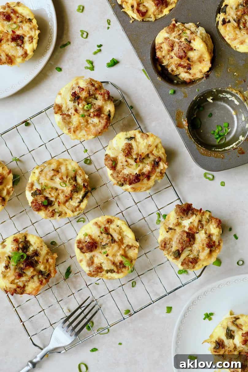 Overhead photo displaying a vibrant breakfast spread featuring Hash Brown Breakfast Muffins with Poblano Peppers and Gouda Cheese, some still in the muffin pan and others plated for serving.