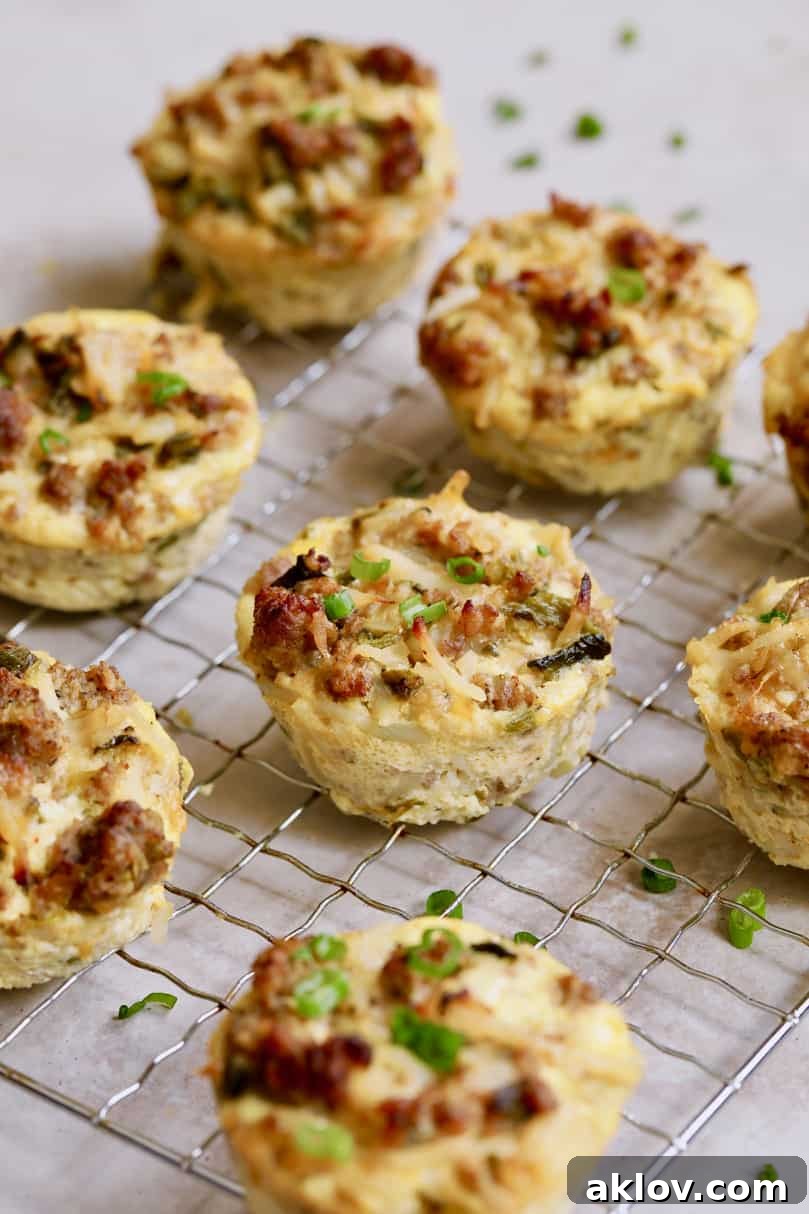 Another beautiful shot of Hash Brown Breakfast Muffins with Poblano Peppers and Gouda Cheese arranged on a cooling rack, with fresh herbs for garnish.