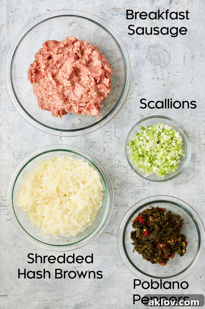 Overhead view showcasing a selection of raw ingredients for breakfast muffins, including peppers, sausage, and cheese.