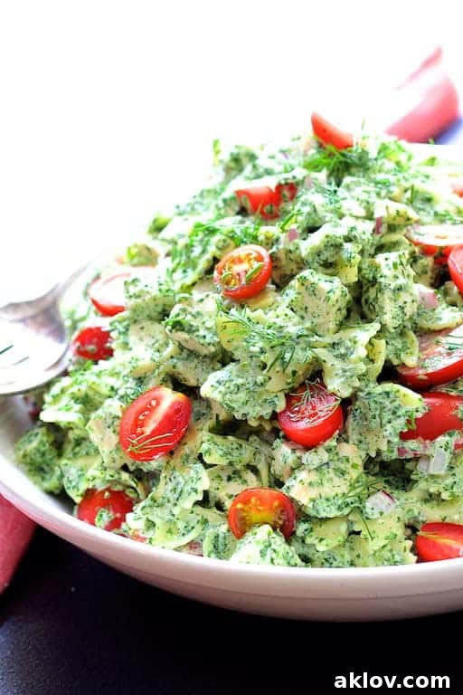 Close-up photo of Chicken Pasta Salad with Spinach Buttermilk Dressing in a white bowl, showcasing its creamy texture and fresh ingredients.
