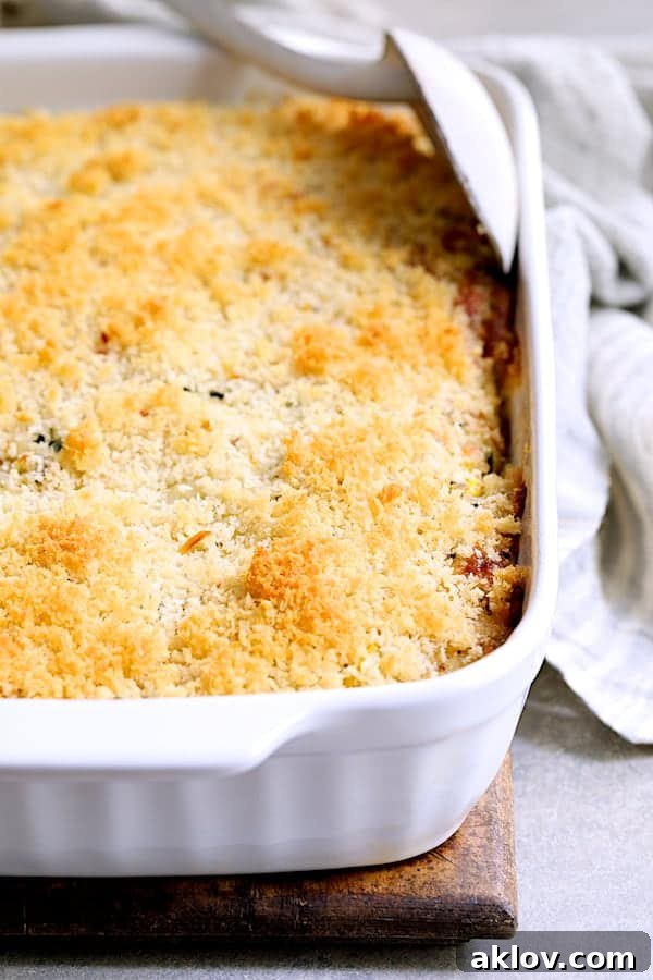 The unbaked Zucchini, Yellow Squash and Quinoa Casserole, perfectly assembled in a white baking dish, ready to be baked to golden perfection.
