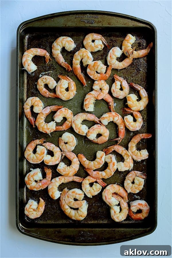 Photo of roasted shrimp on baking sheet.