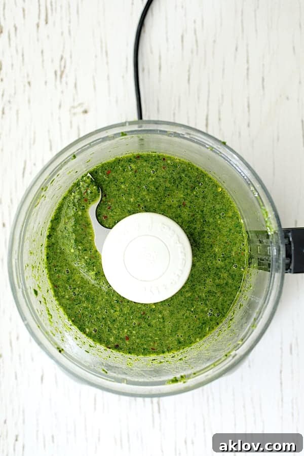 Photo of Purslane Chimichurri in a food processor after blending, showing a vibrant green texture.
