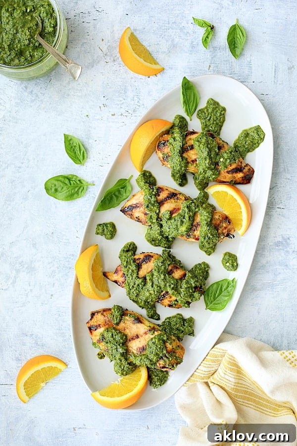 Photo of Grilled Citrus Chicken with Spicy Basil Chimichurri Sauce on white oval platter.
