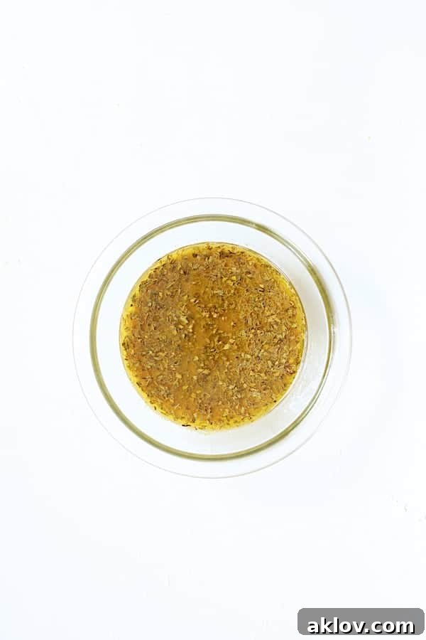 Photo of citrus marinade in glass bowl on white background.