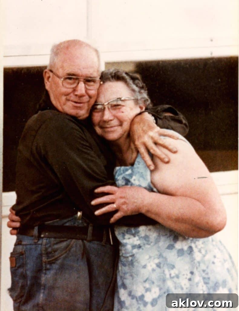 Photo of an elderly couple, Louie and Viola Langhoff, embracing warmly.