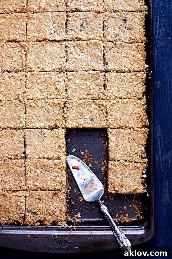 Photo of Healthier Date Bars in a baking pan, with a server ready to portion.
