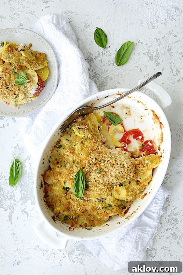 Photo of Yellow Squash and Tomato Gratin with Two Cheeses with some of the gratin served onto a small white plate.
