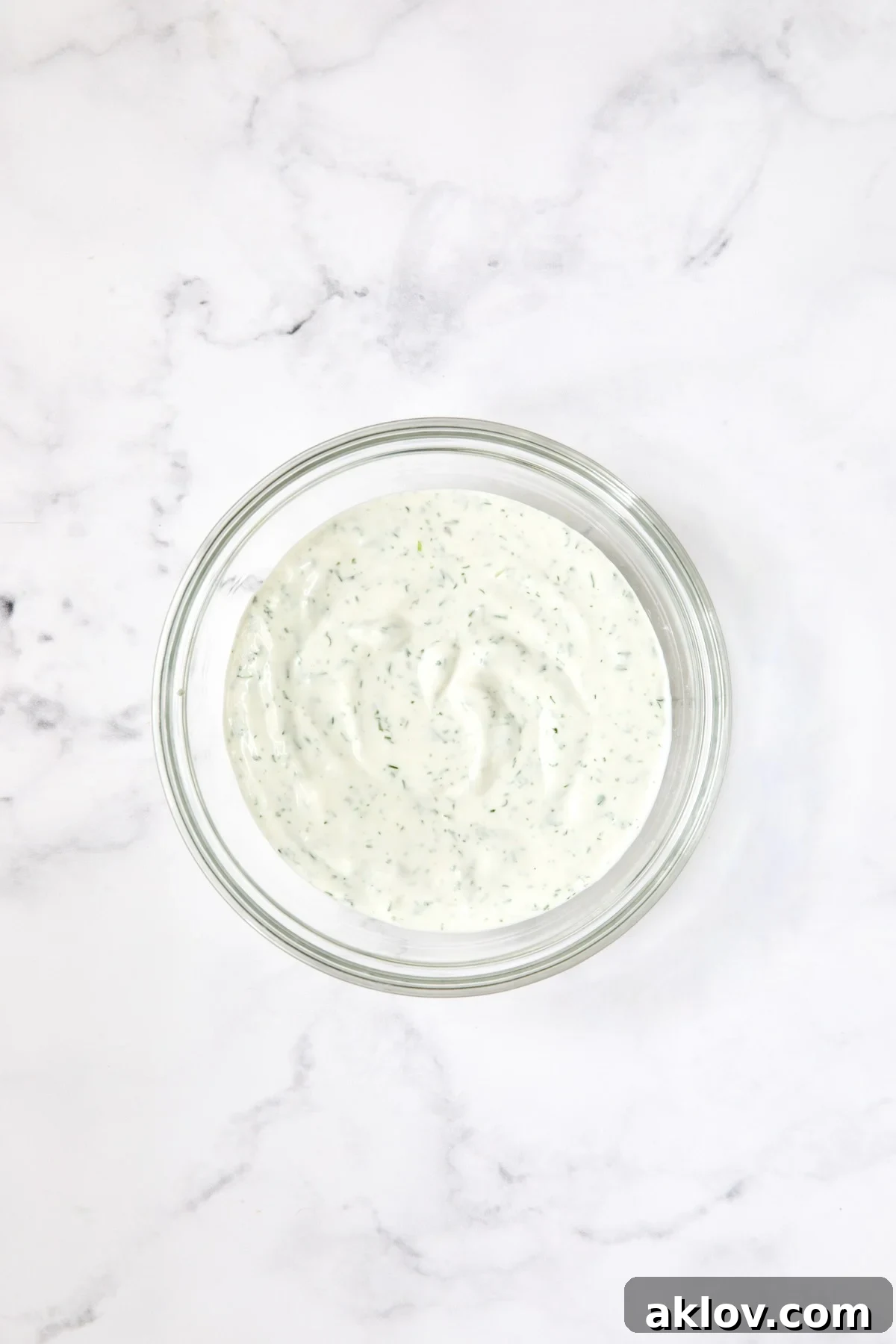 Salad dressing in glass bowl.