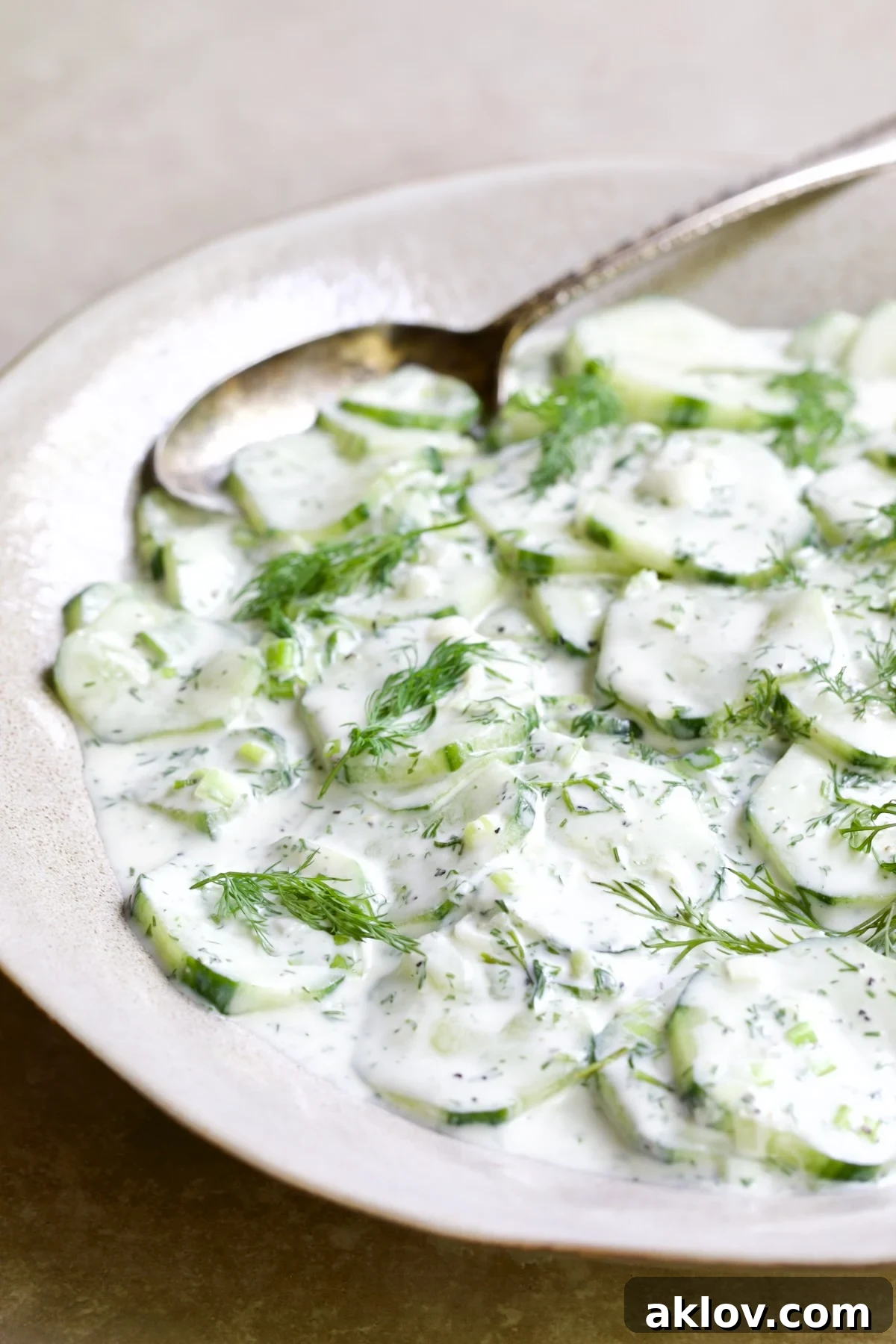 Yogurt Ranch Cucumber Salad in serving bowl with serving spoon.