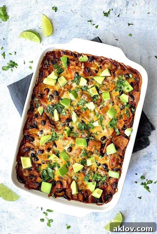Black Bean and Yellow Squash Enchilada Casserole with serving spoon before being cut.