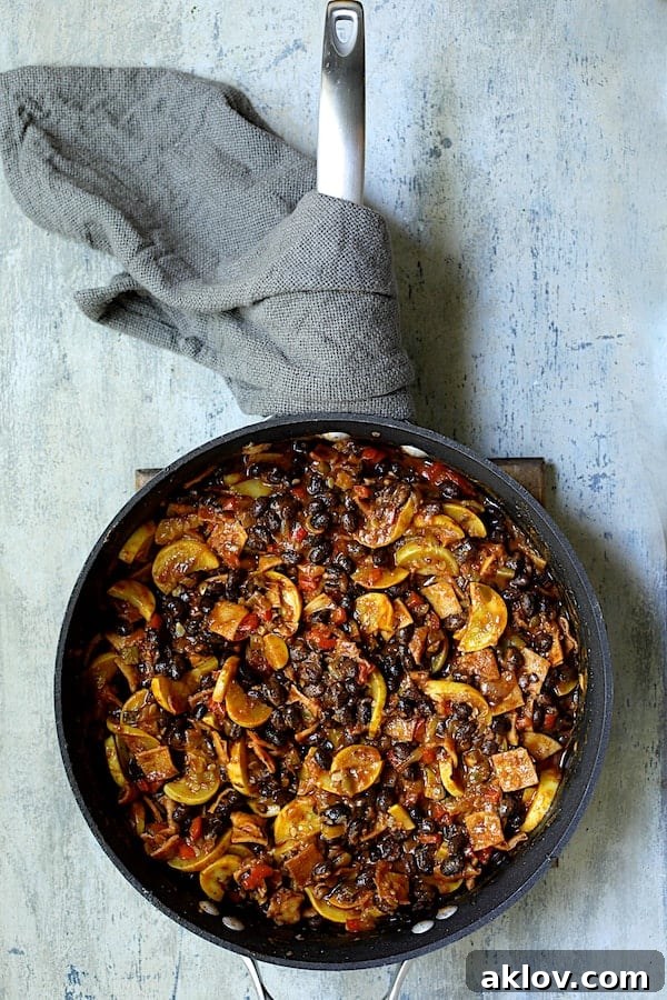 Photo of ingredients for Black Bean and Yellow Squash Enchilada Casserole combined in skillet.