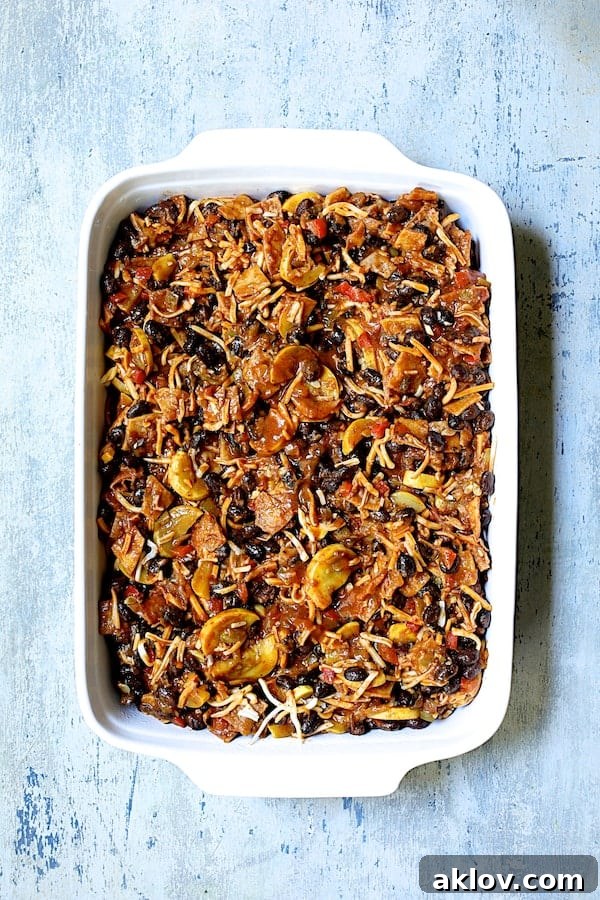 Photo of assembled casserole in white ceramic baking dish.