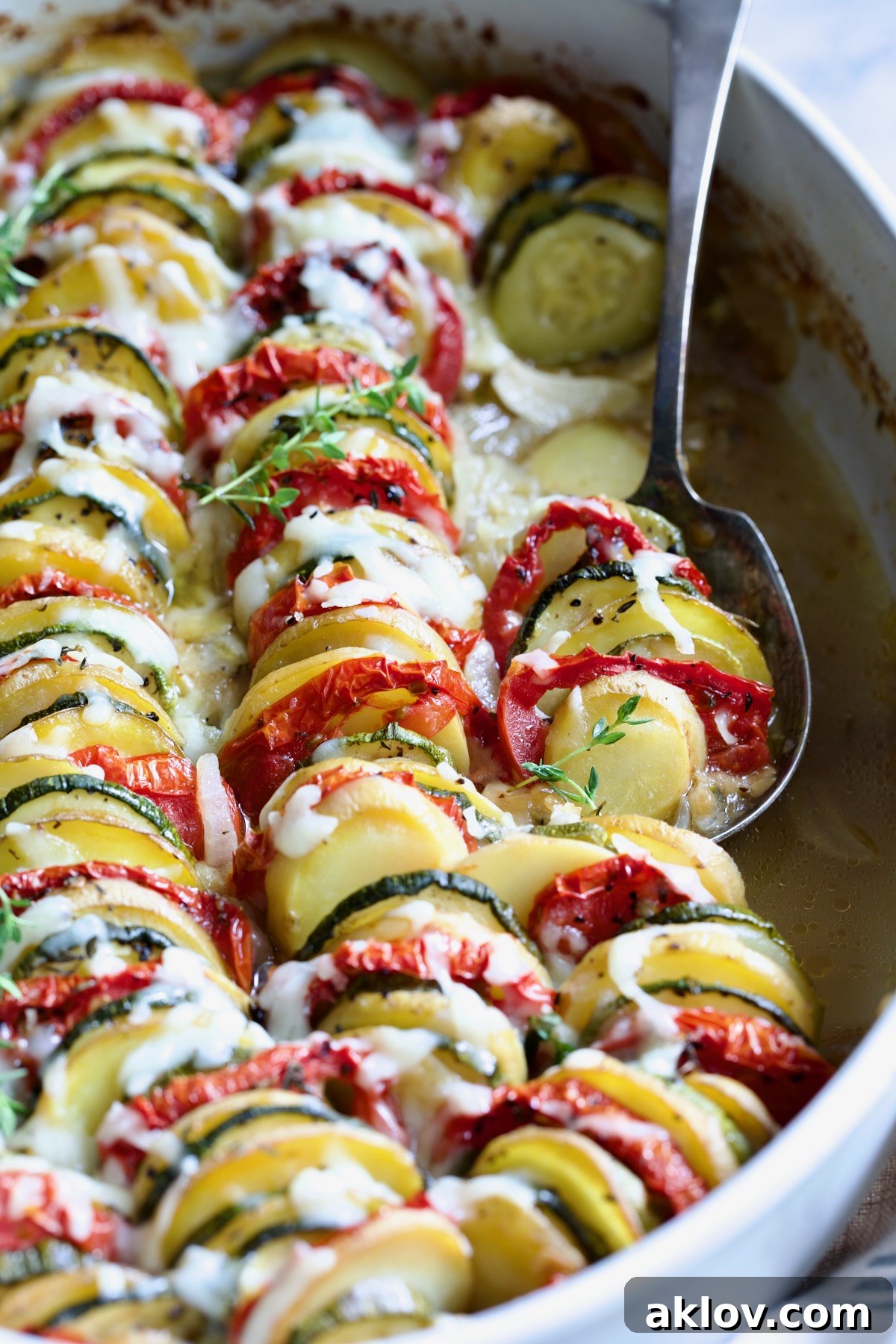 Vegetable Tian in oval baking dish with serving spoon.